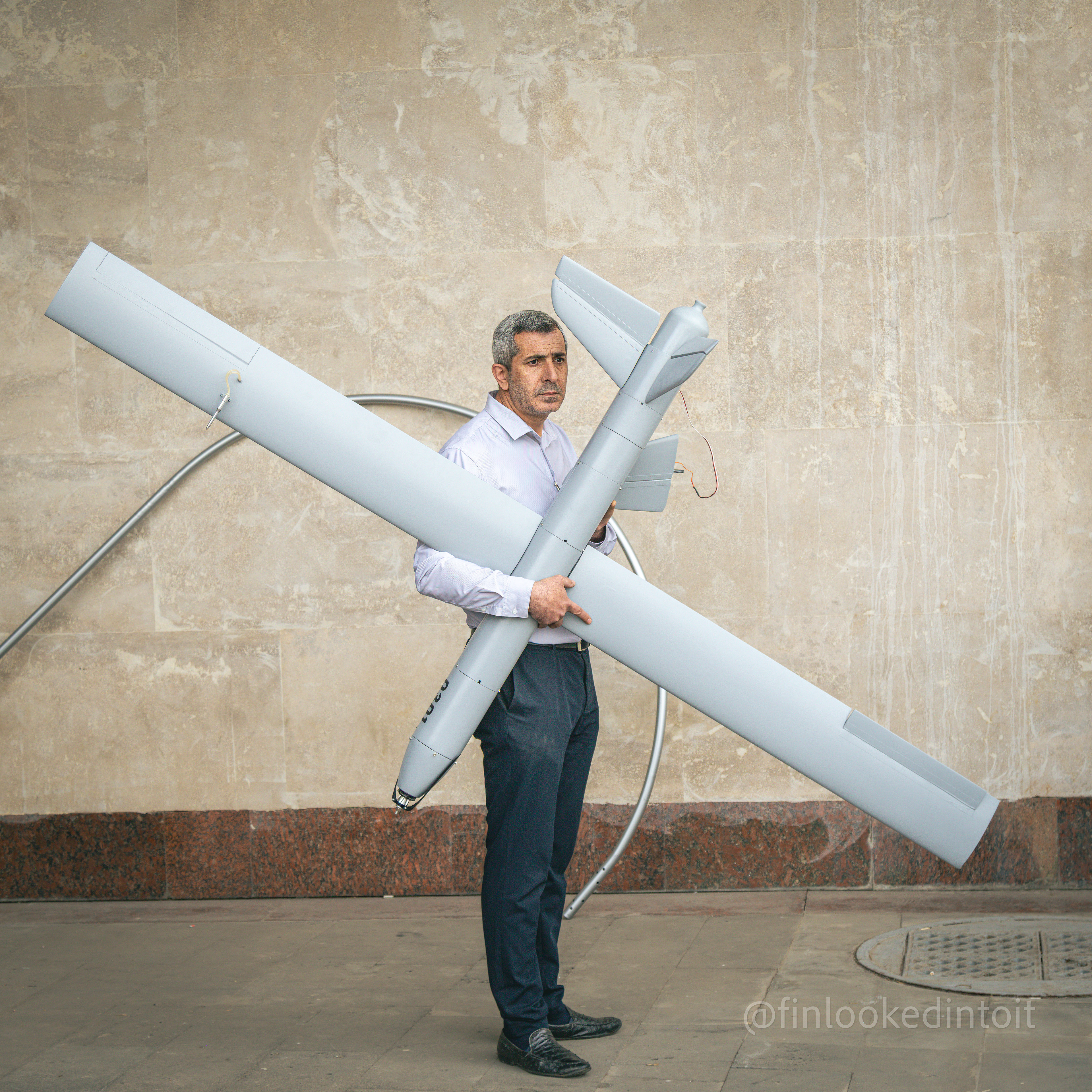 An Armenian man holding a UAV at a weapons exposition in Yerevan, 04/31/2021