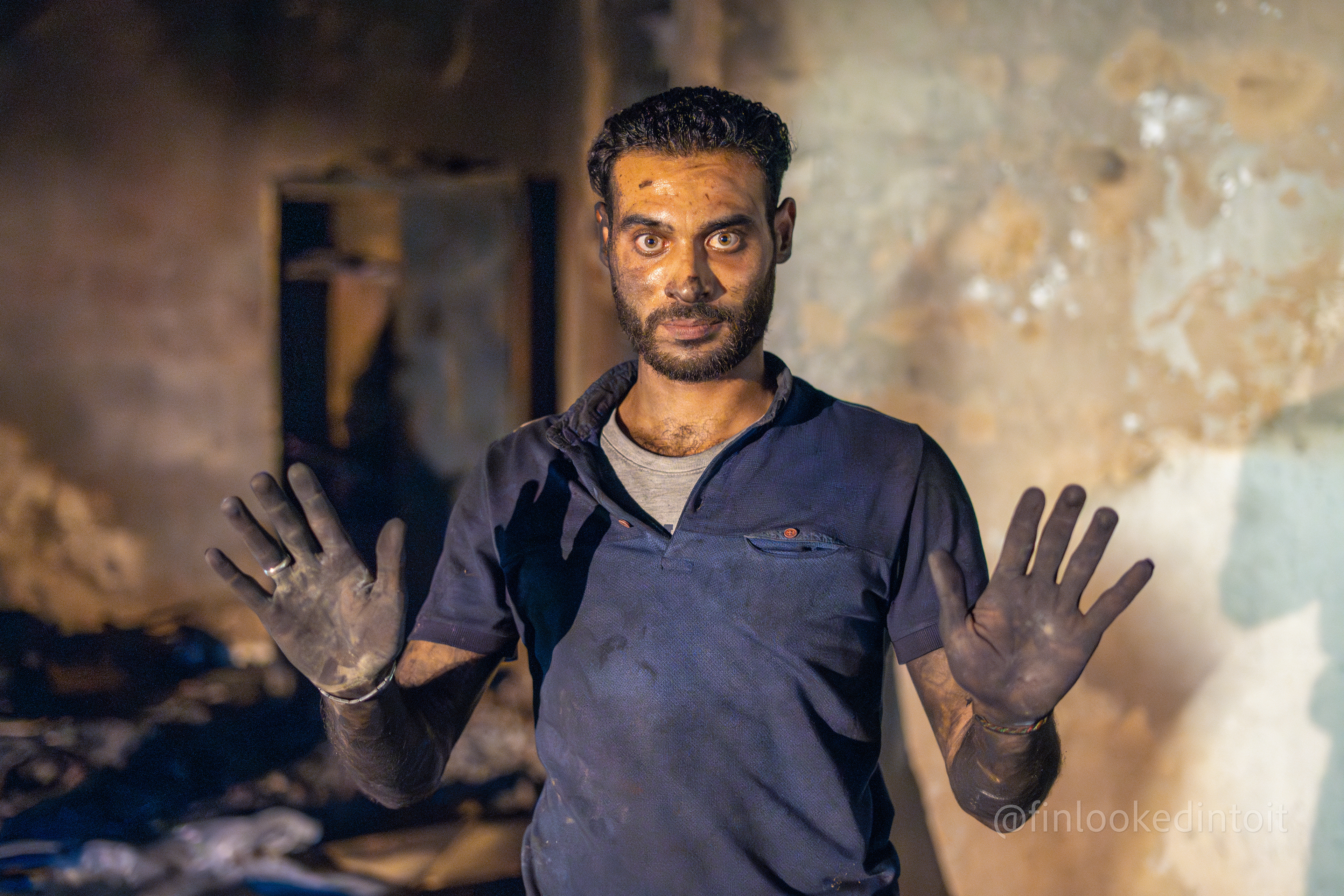 A Lebanese man sifting through his friend's shop after it was torched by anti-Israel rioters in Beirut, 10/18/2023