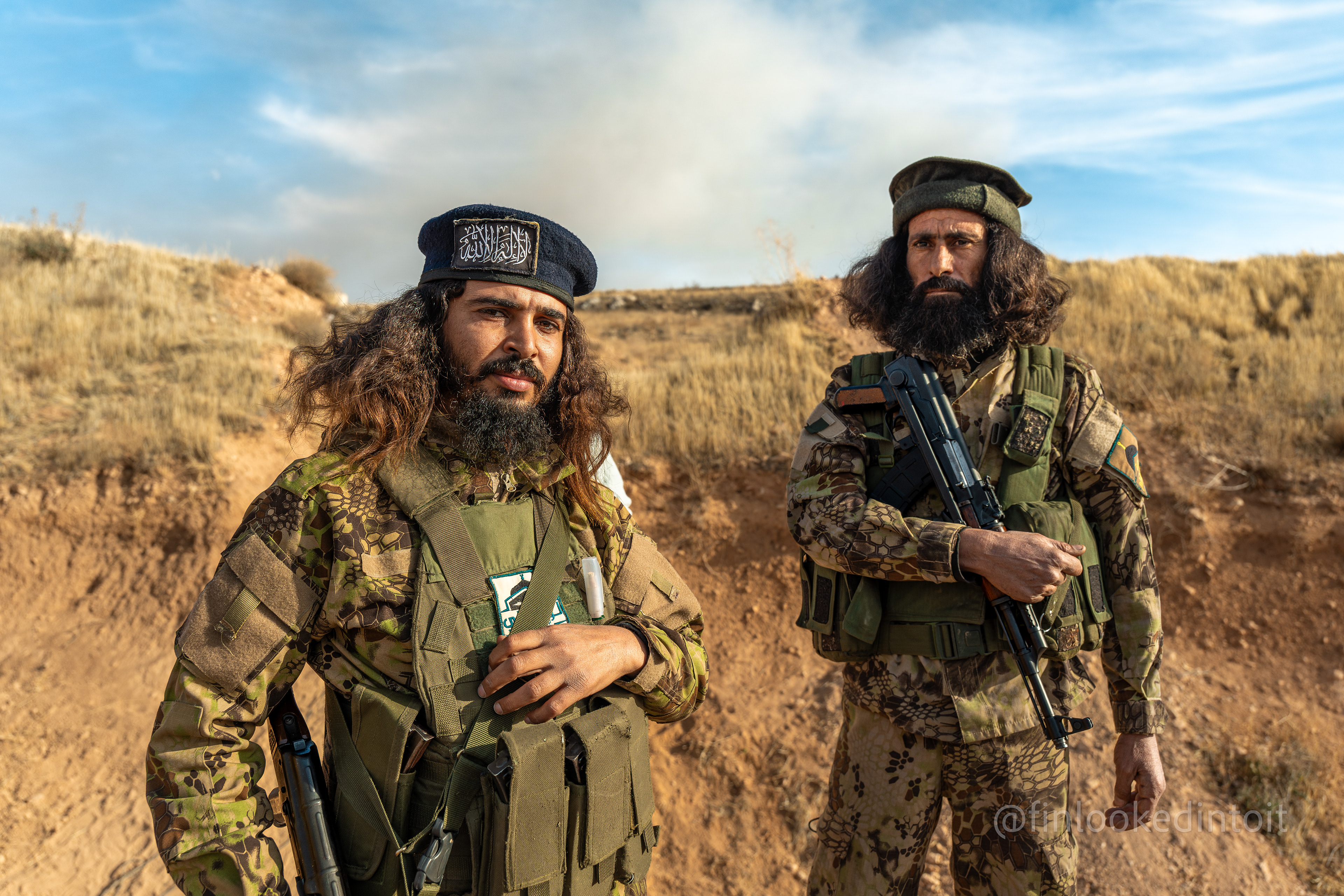 Afghan volunteers of Hay'at Tahrir al-Sham pose for a photo on the outskirts of the Sednaya prison, Syria, 12/10/2024