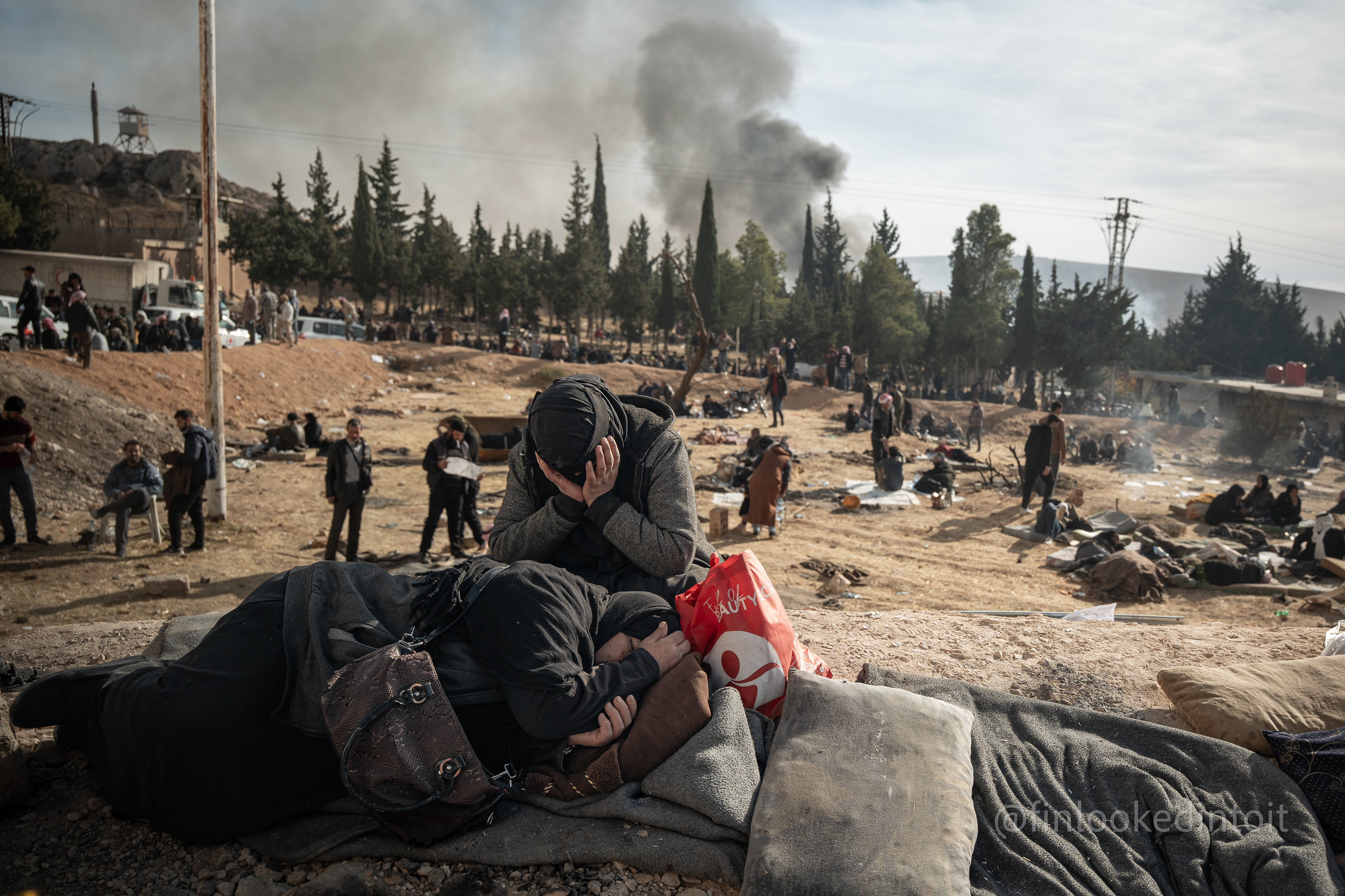 Two women despairing on the outskirts of the Sednaya prison, Syria, 12/10/204