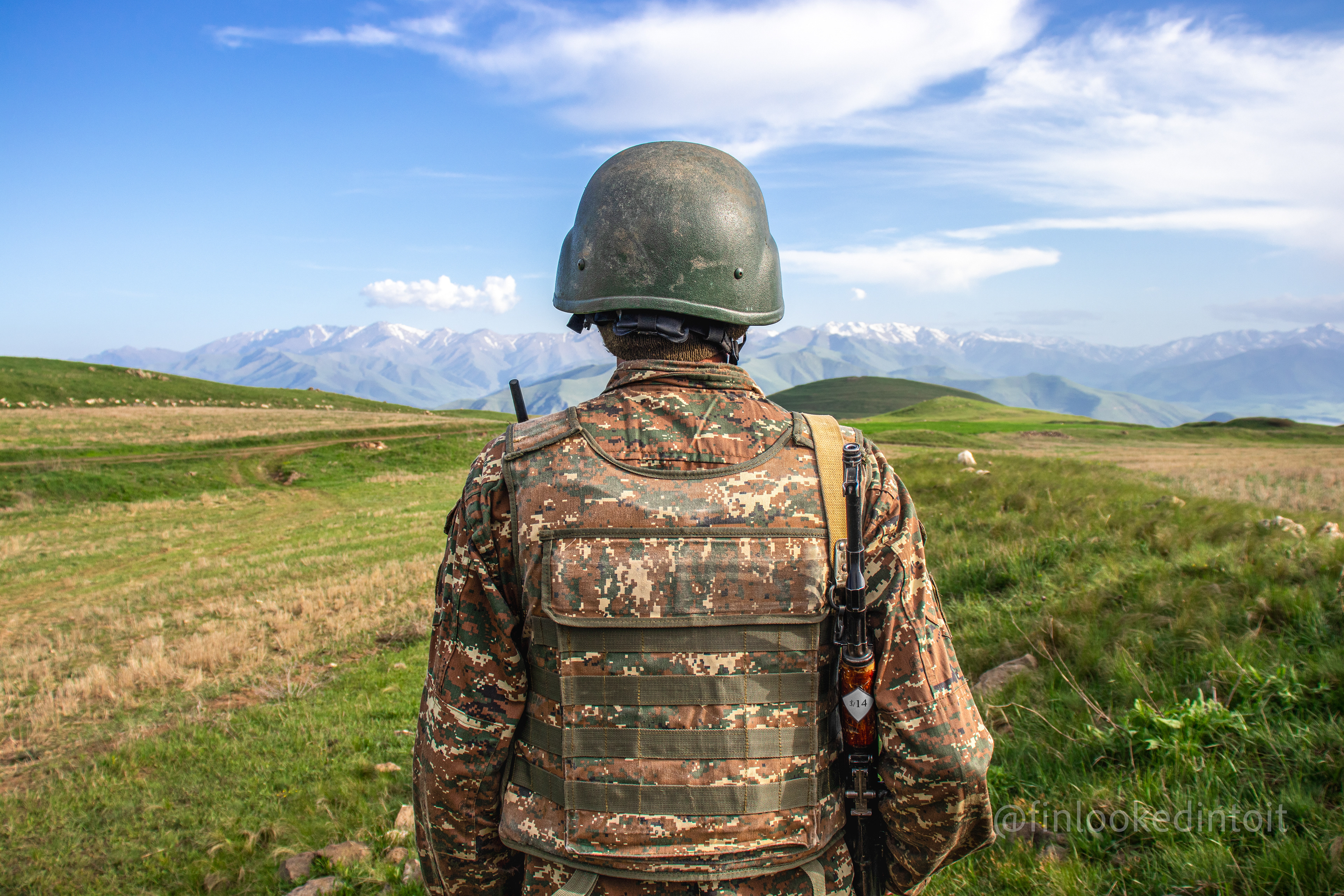 An Armenian soldier stares into the distance towards the Azerbaijani exclave of Nakhichevan, 05/21/2021