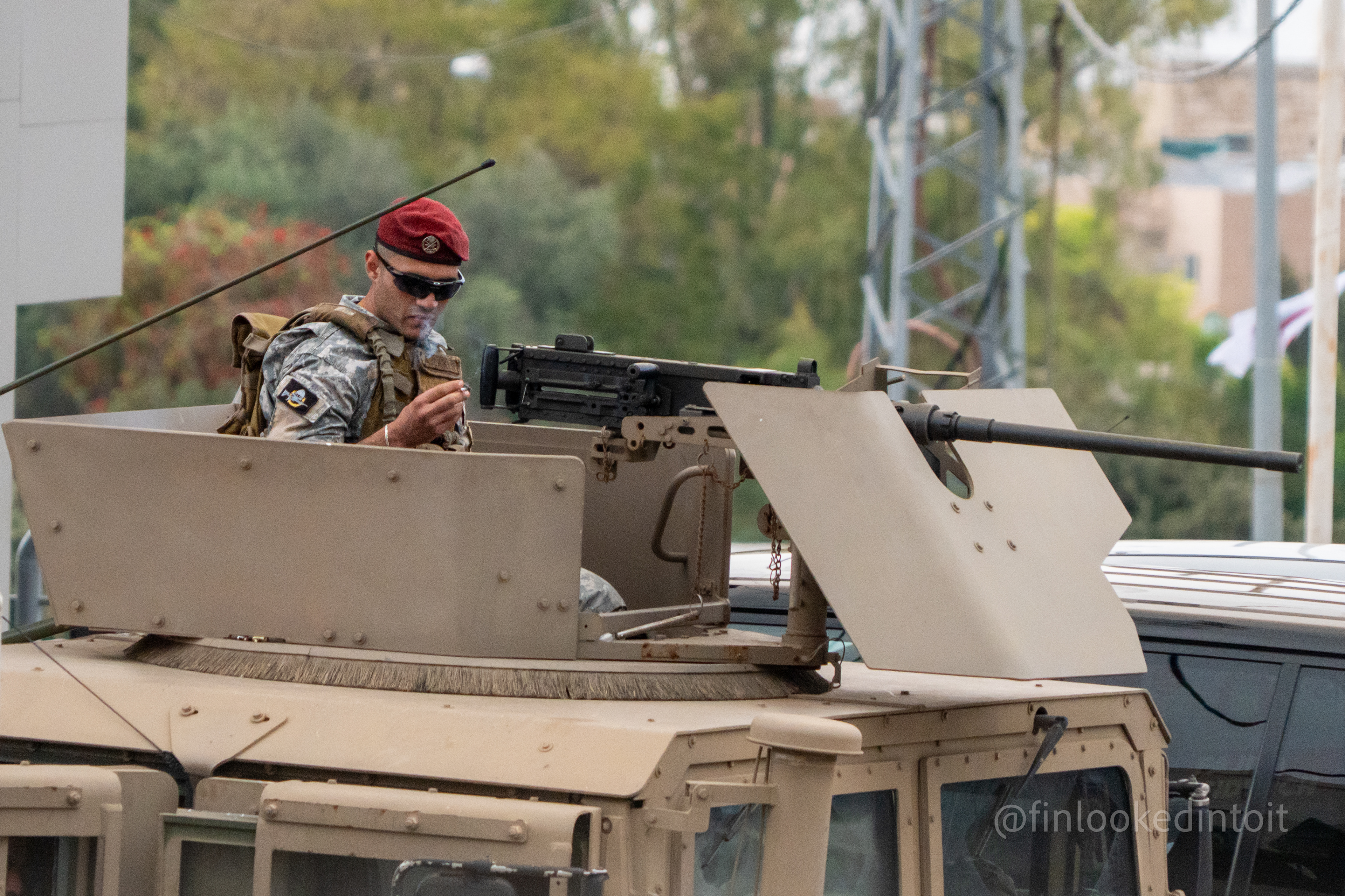 A Lebanese soldier smokes a cigarette at the helm of his Browning machine gun in Byblos, 04/12/2024