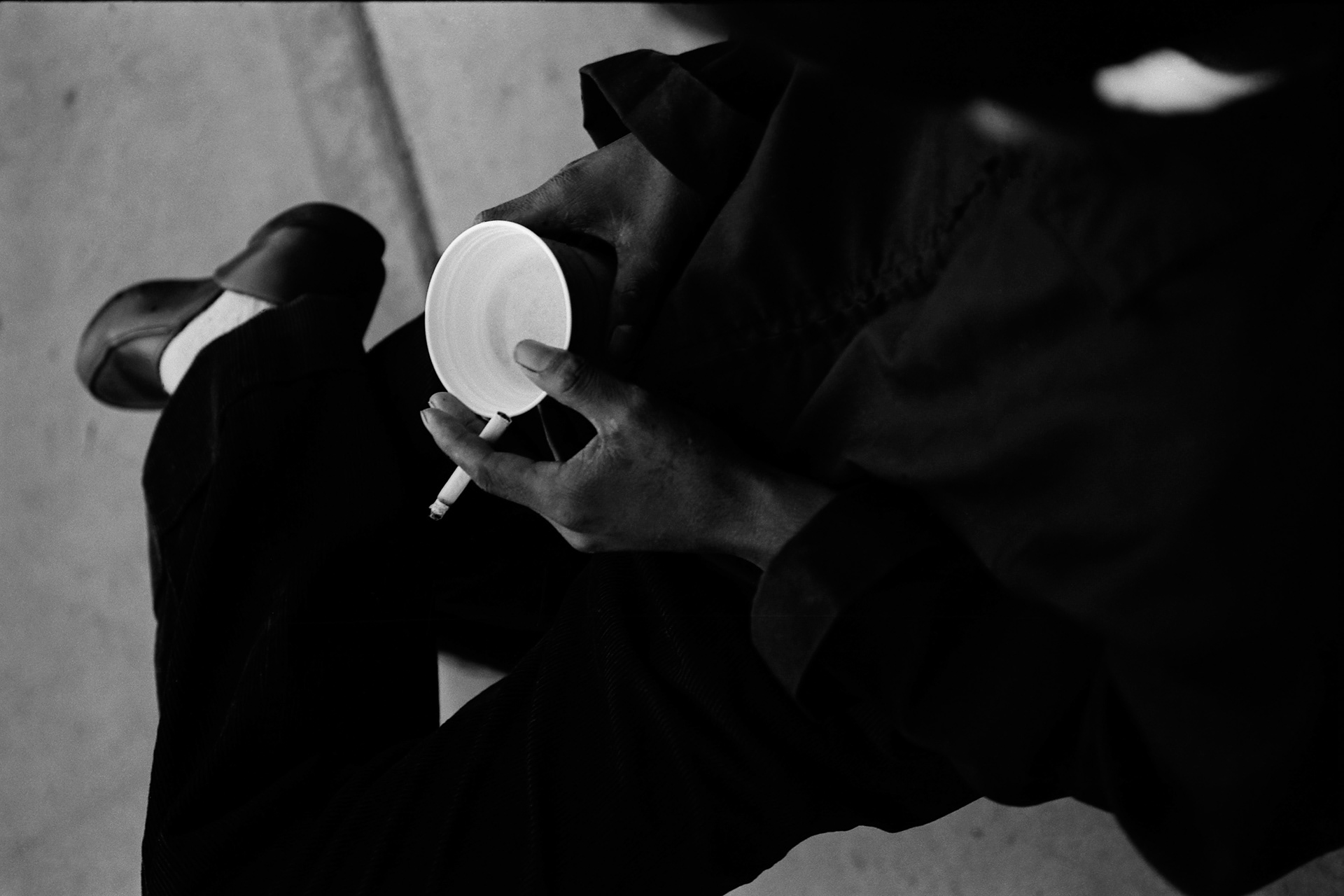Man with cigarette and beer cup