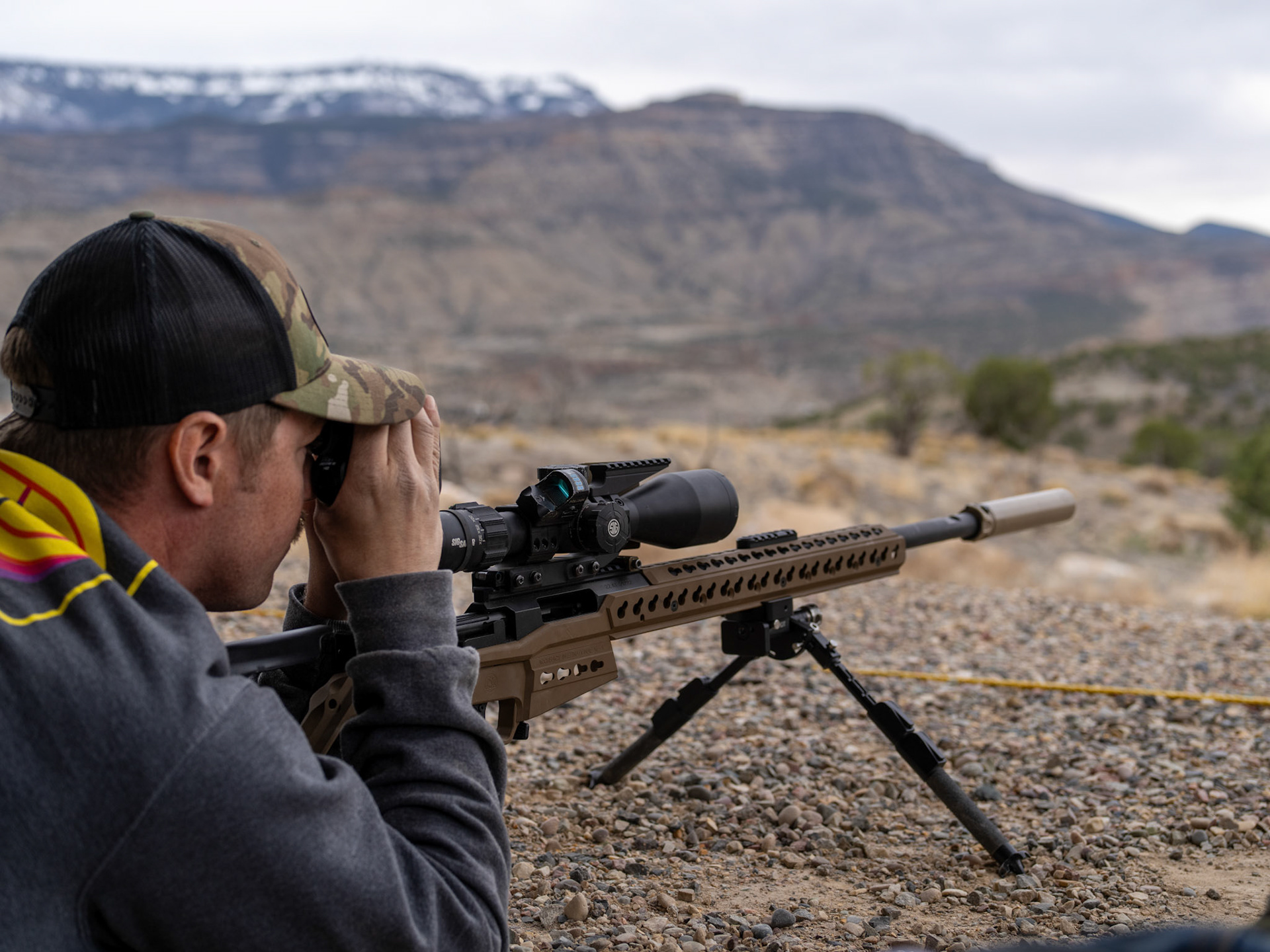Close up on shooter using rangefinder