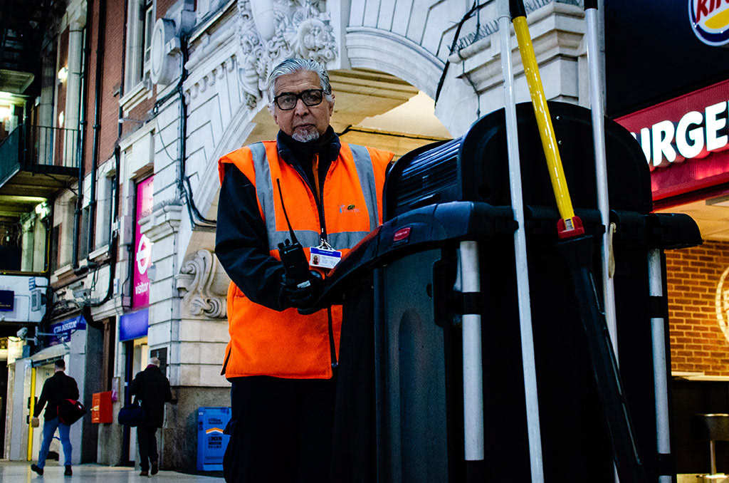 Bachir, a cleaner working for Network Rail in Victoria Station, pushes his trolley while holding a walkie-talkie in London, England, November 24, 2018. 