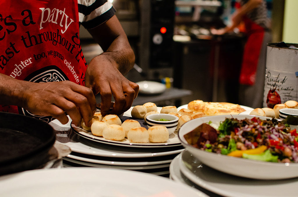 Peter, a chef at Pizza Express, plates doughballs fresh out the oven alongside dips for Jade, a waitress, to serve them, in Falmouth, England, December 1, 2018. 