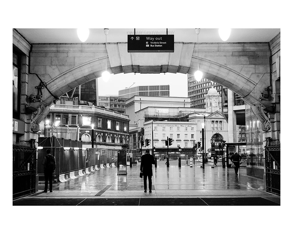 Isolation in London Transport; The City That Never Speaks. 5/5 A man stands in an archway looking out at the rain-dampened city, ready to meet someone he knows, in London Victoria Station, England, November 26, 2018. 