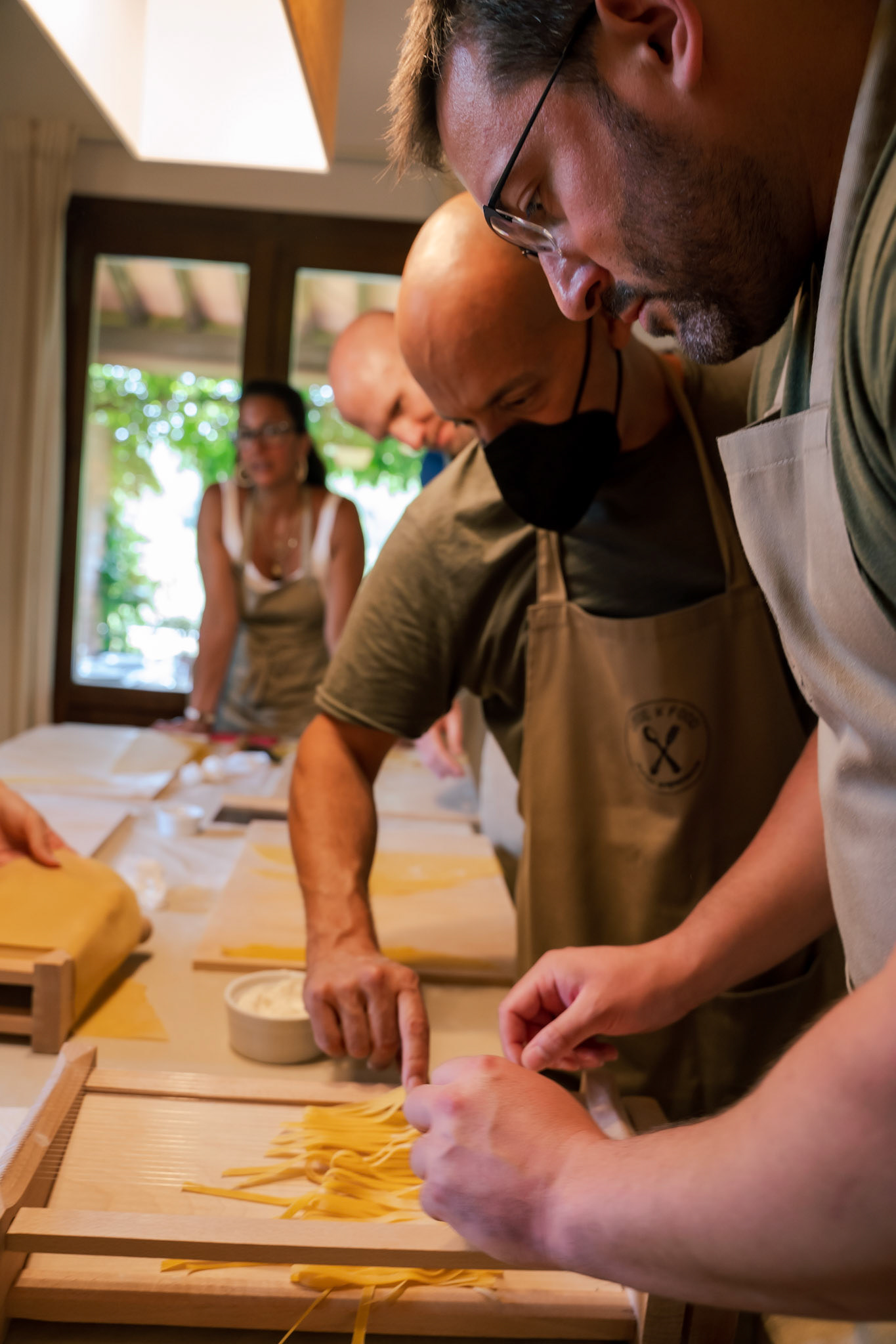 Dave using a chitarra to cut the pasta dough into fettuccine