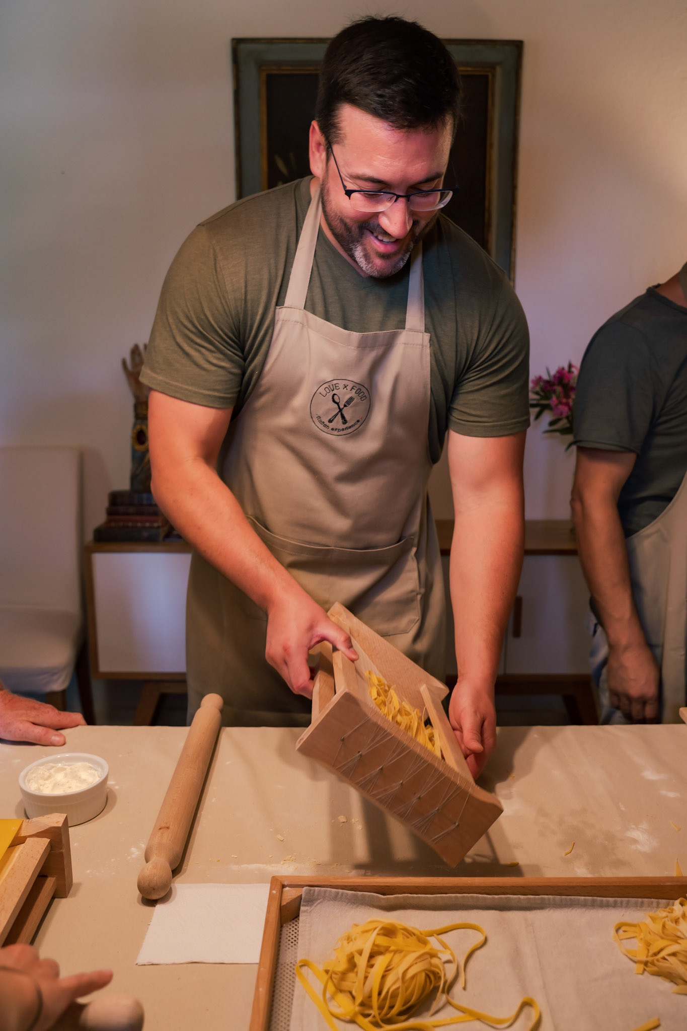 Dave using a chitarra to cut the pasta dough into fettuccine