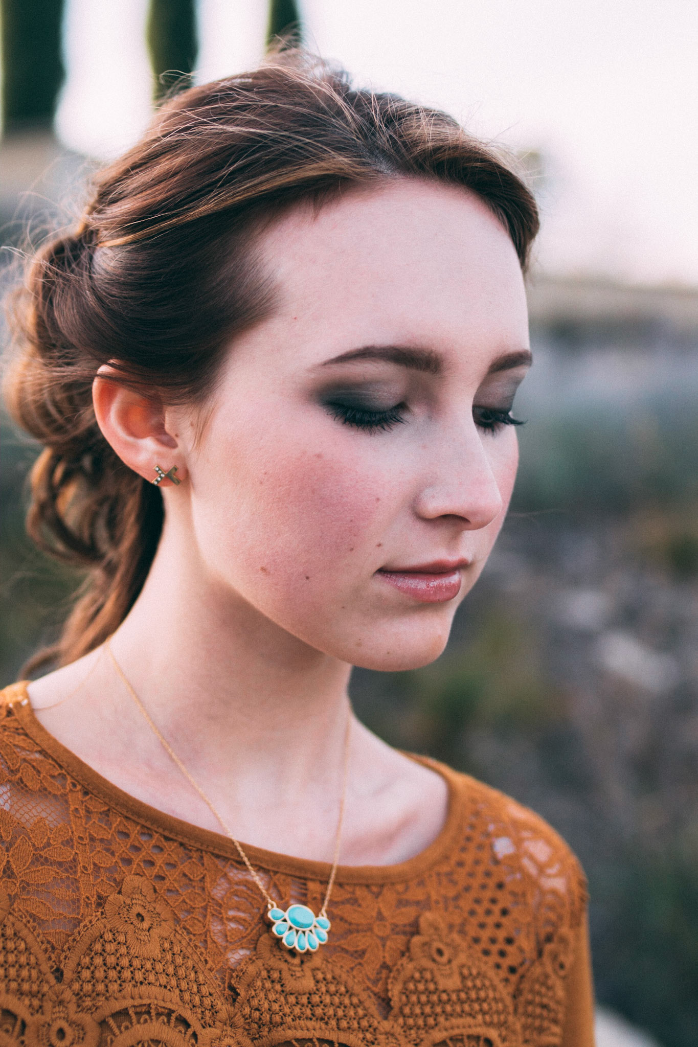 Portrait of a young woman adorned in jewelry for the fashion brand Bien-aime.