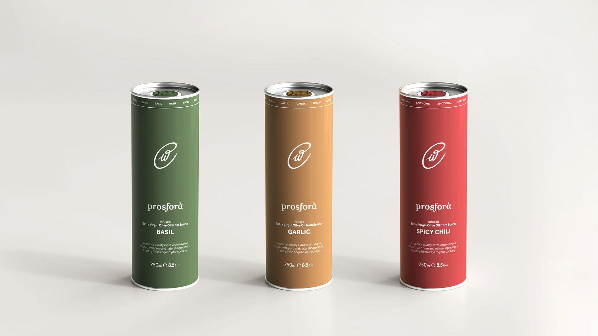 Three Prosfora olive oil 250ml tin cans of the flavored varieties, placed next to each other to showcase the packaging design. They all feature the prosfora logotype that resembles an olive at the center, while typography is at the bottom part of the tin. The tins are categorized by color. Green for basil flavored olive oil, amber for garlic flavored olive oil and red for spicy chili flavored olive oil.