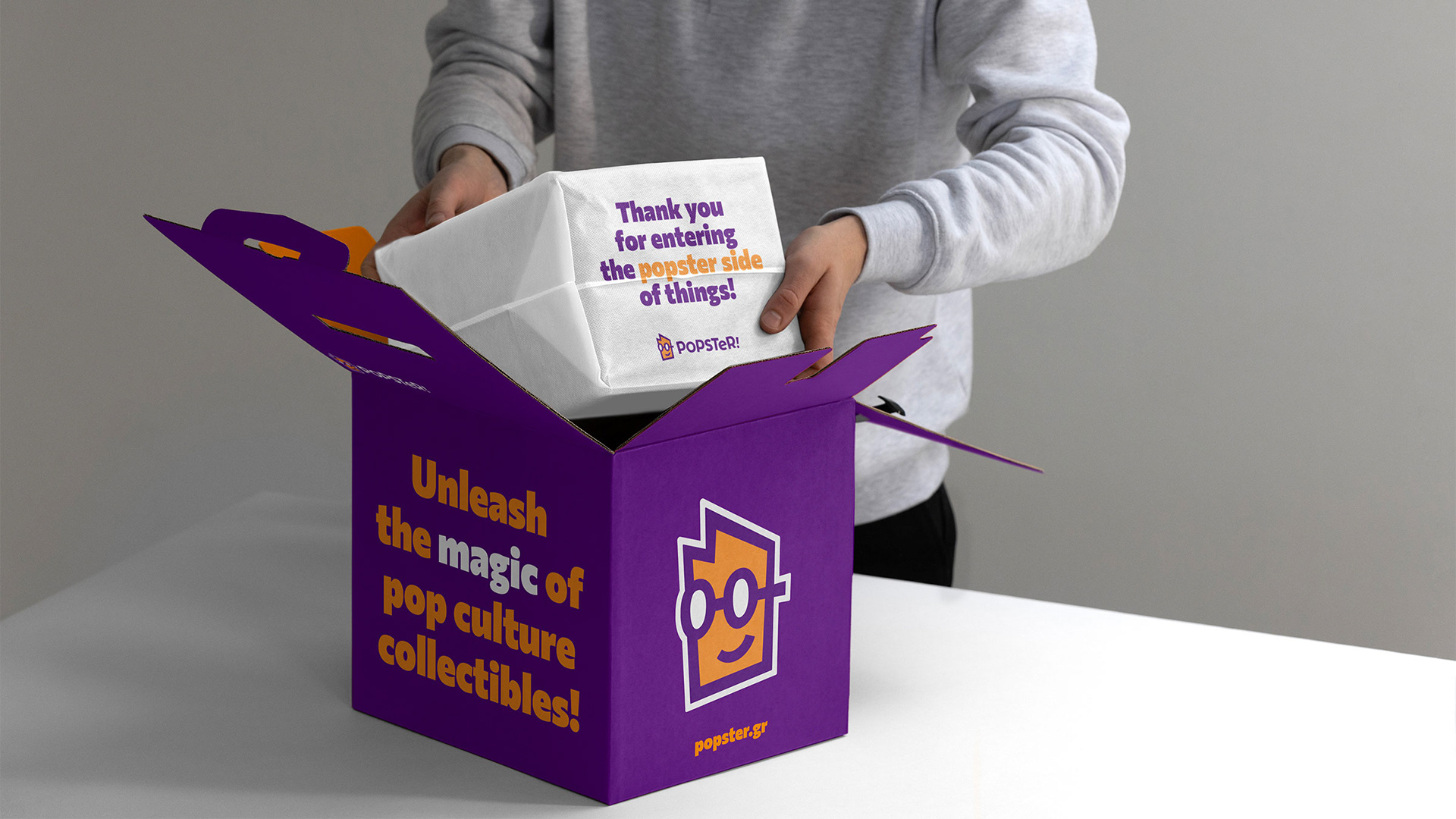 Popster custom designed mail box featuring the slogan, logo and website. The item inside is in a wrapping paper featuring a thank you note.