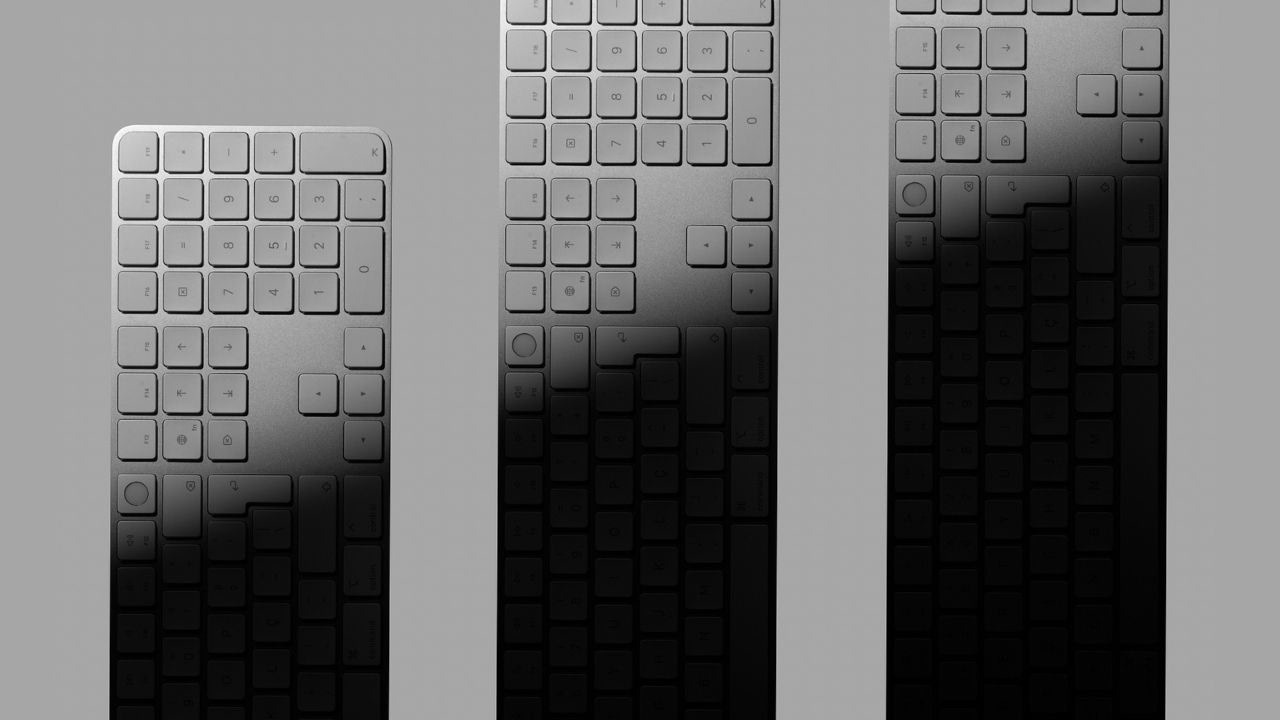 Studio product shot of multiple keyboards arranged vertically, highlighting a minimalist, modern and contemporary aesthetic, with creative lighting