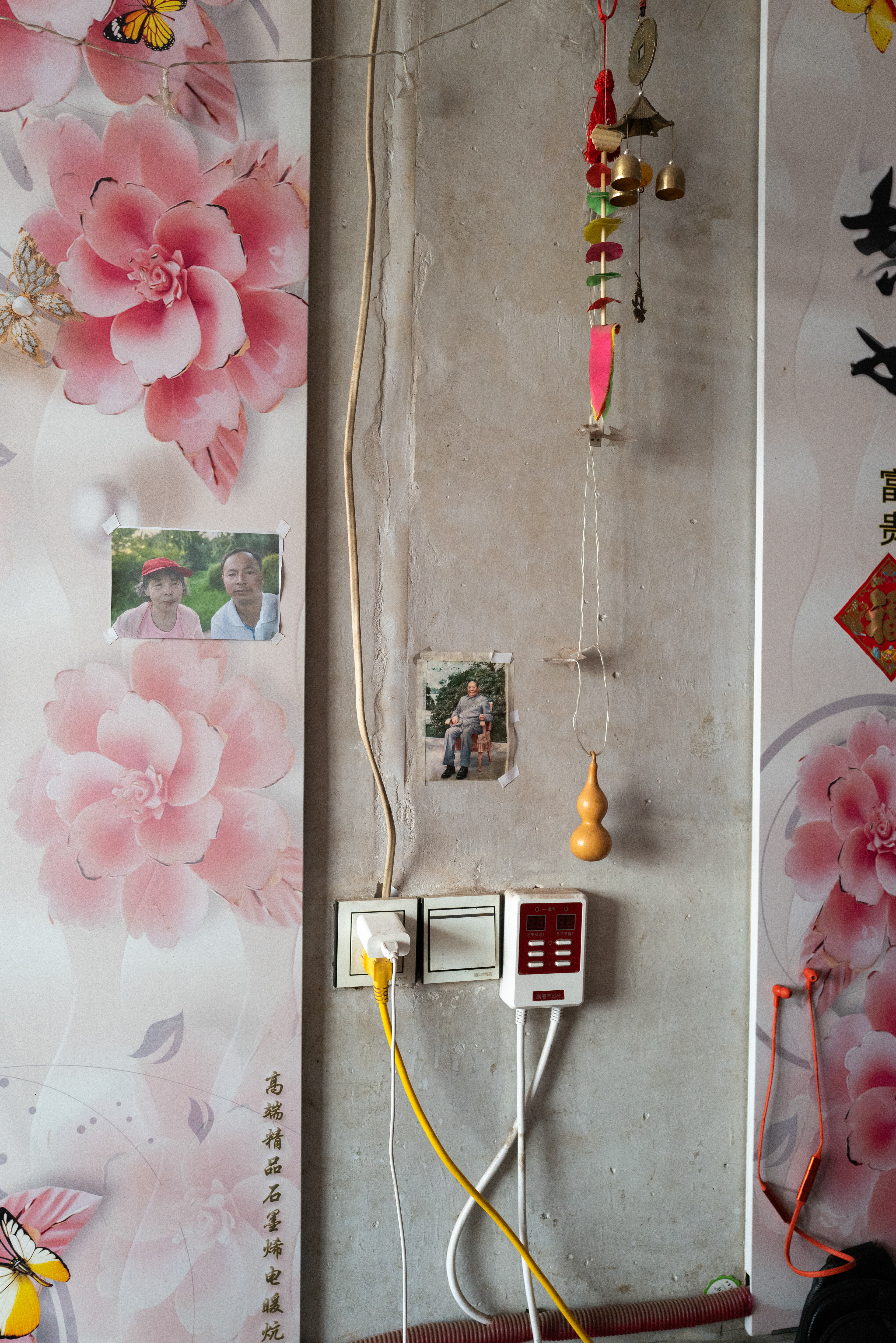 selfie of my third uncle and my grandma, Chairman Mao's photo is sticked on the wall as well.