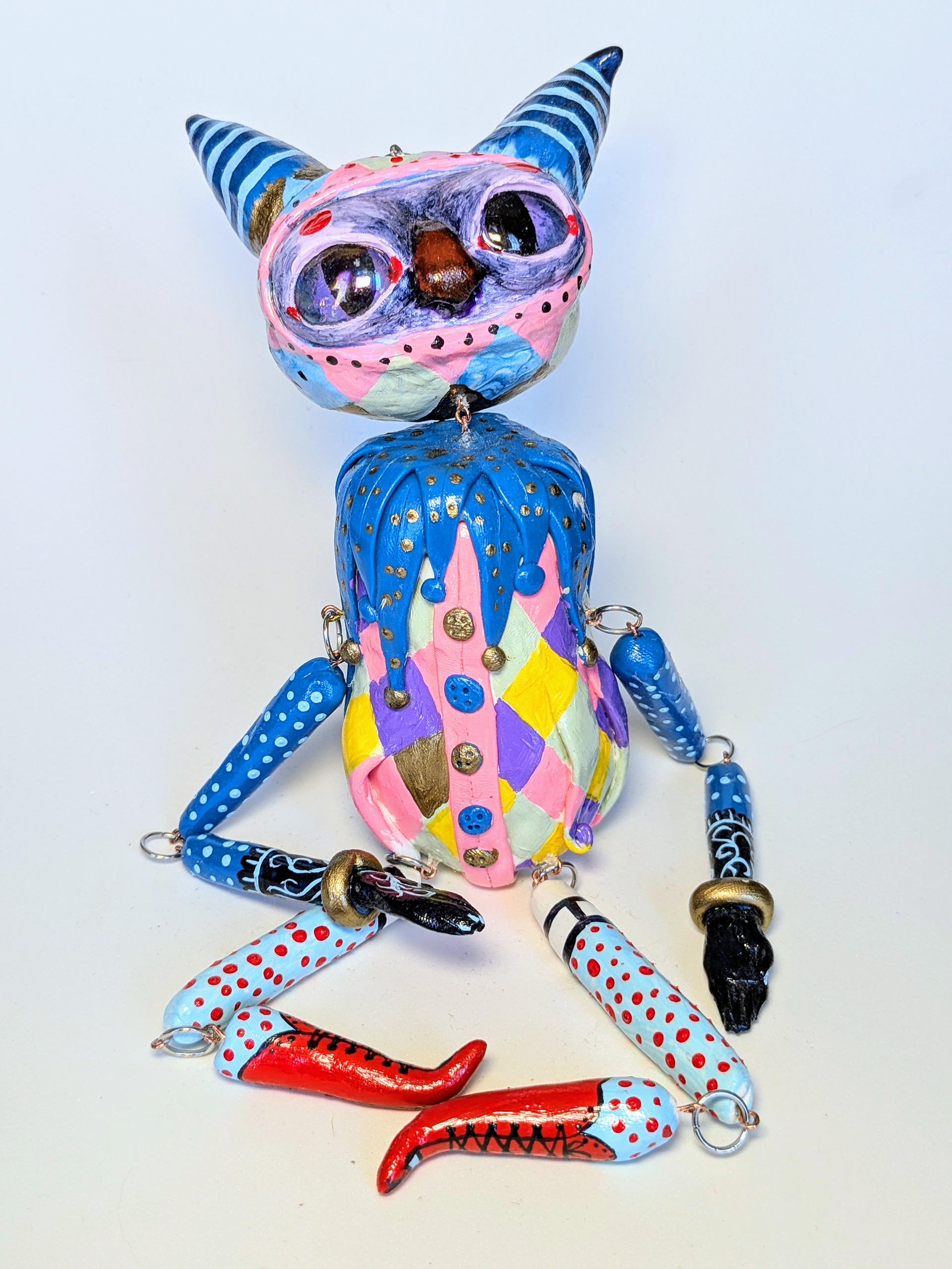 "Circus Imp", 2024. 11x3x2" (lying down), polymer clay, acrylic paint.