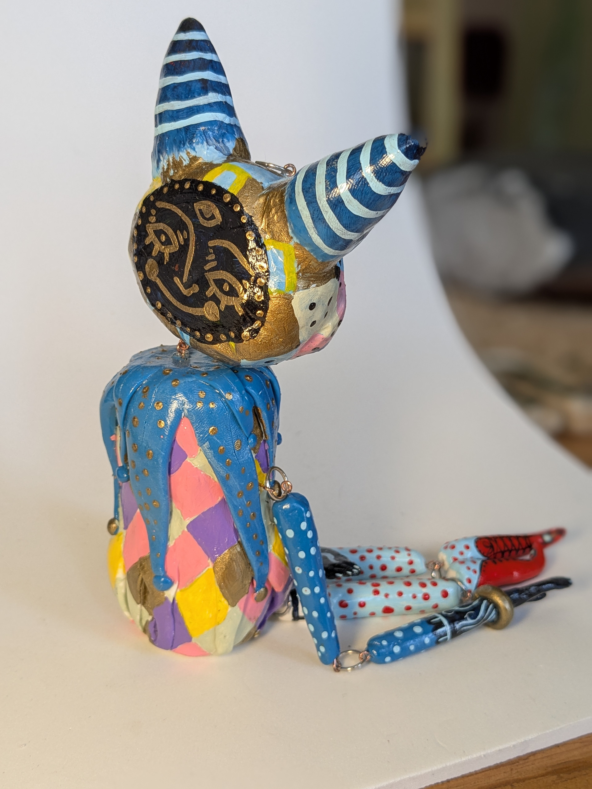 "Circus Imp", 2024. 11x3x2" (lying down), polymer clay, acrylic paint.