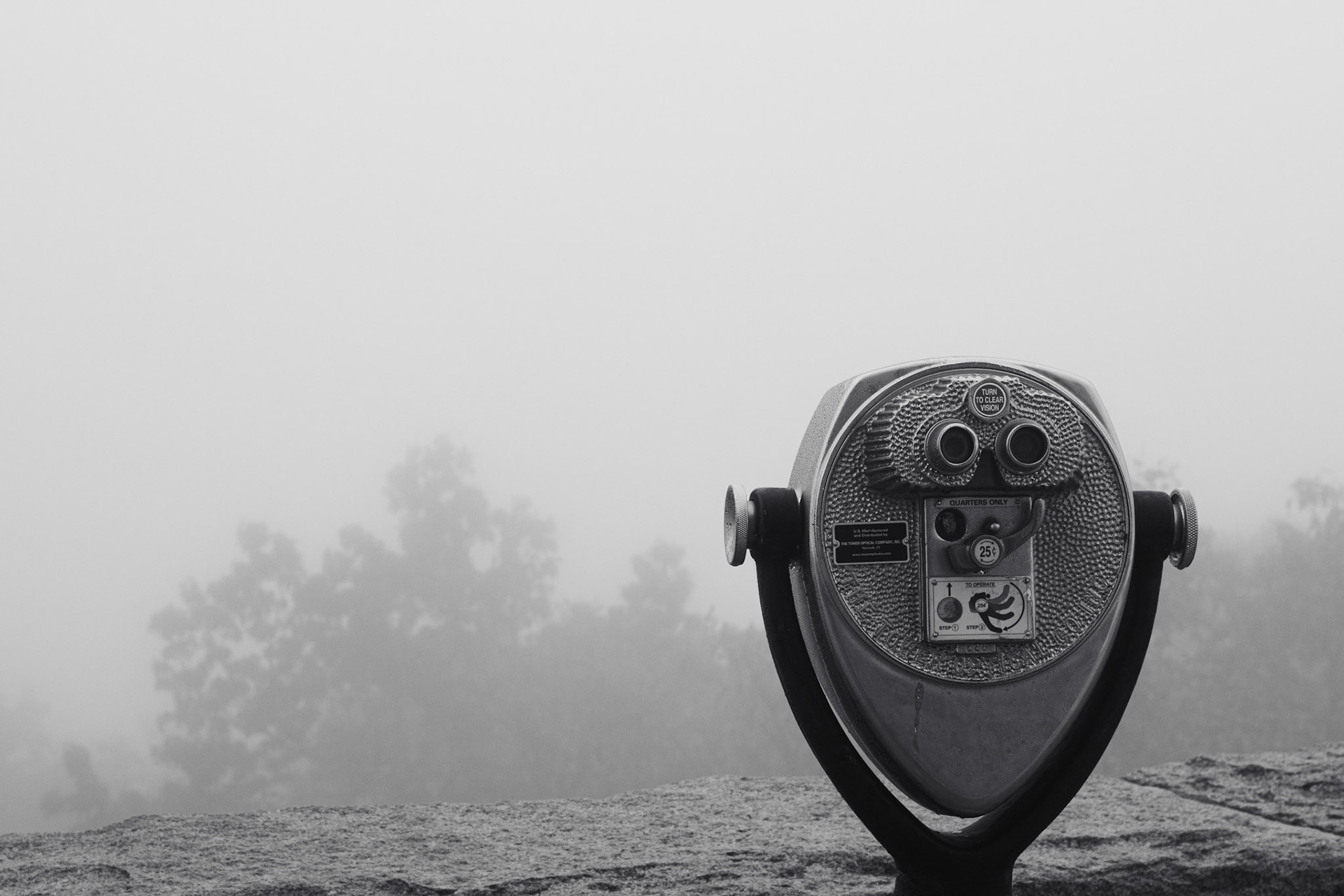 A viewfinder from an overlook stares out into the fog, attempting to see the expansive vista