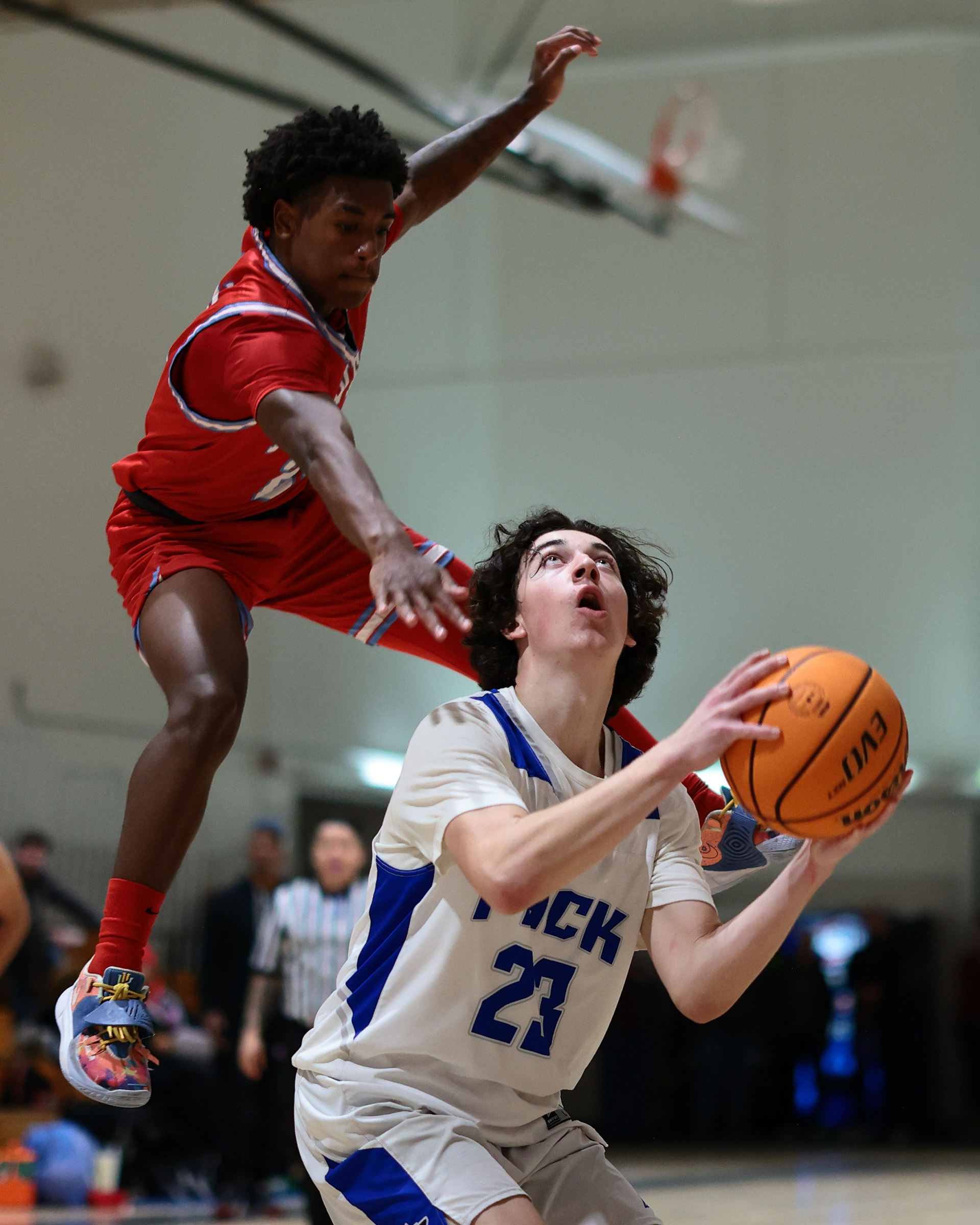West Hills High School basketball player fakes out a defender before taking a shot